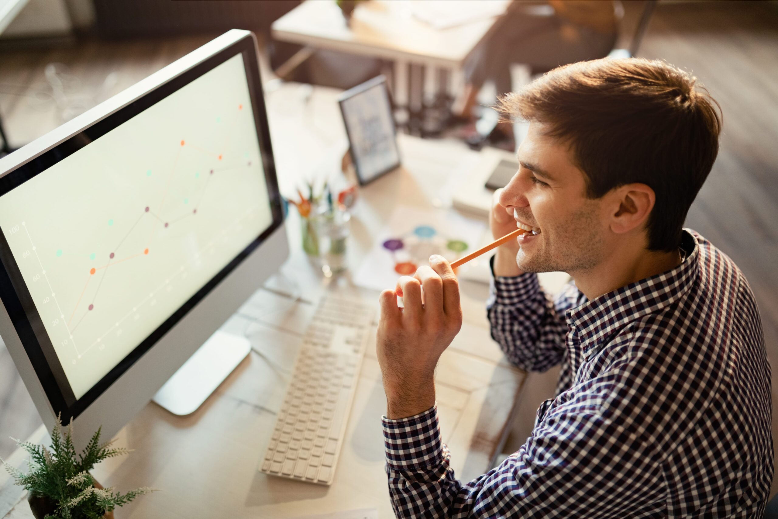 A Google Ads specialist analysing campaign progress through his PC.