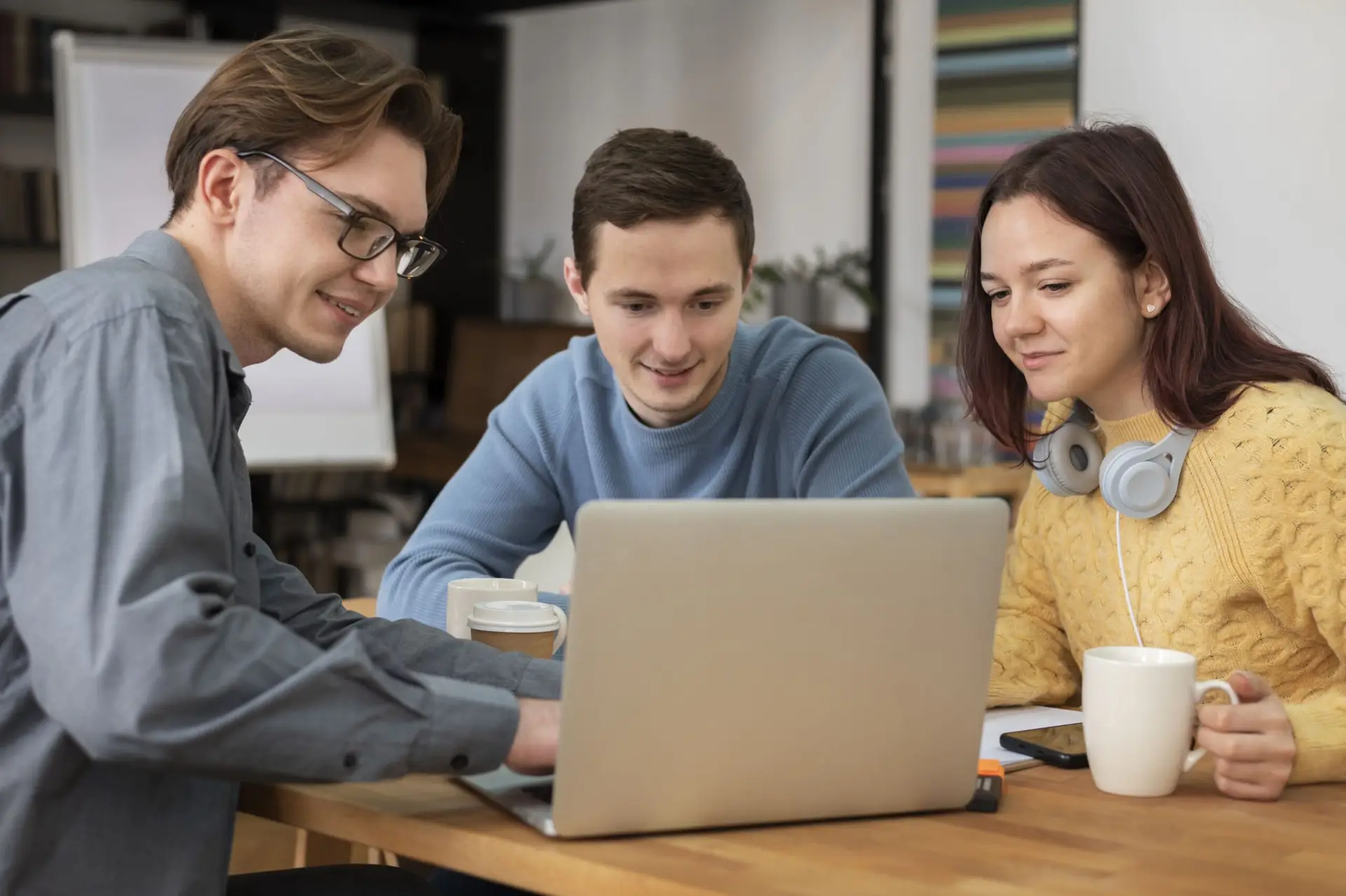 Three colleagues working on a Google Ads strategy