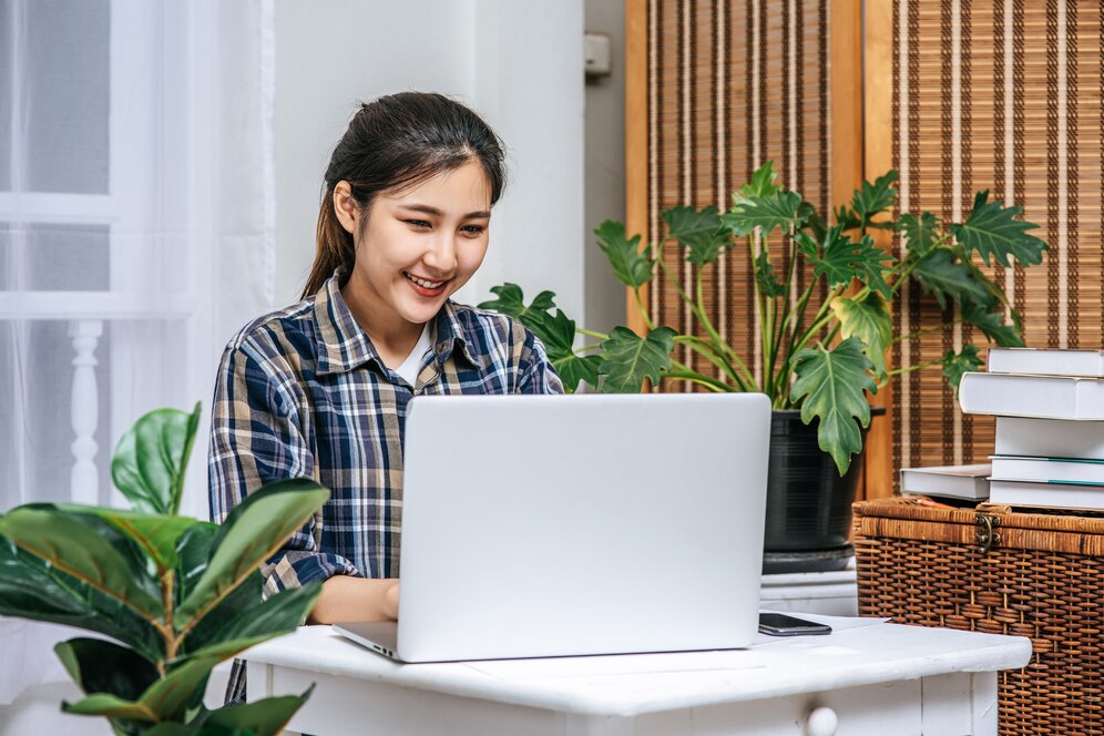 A woman using a laptop in an office