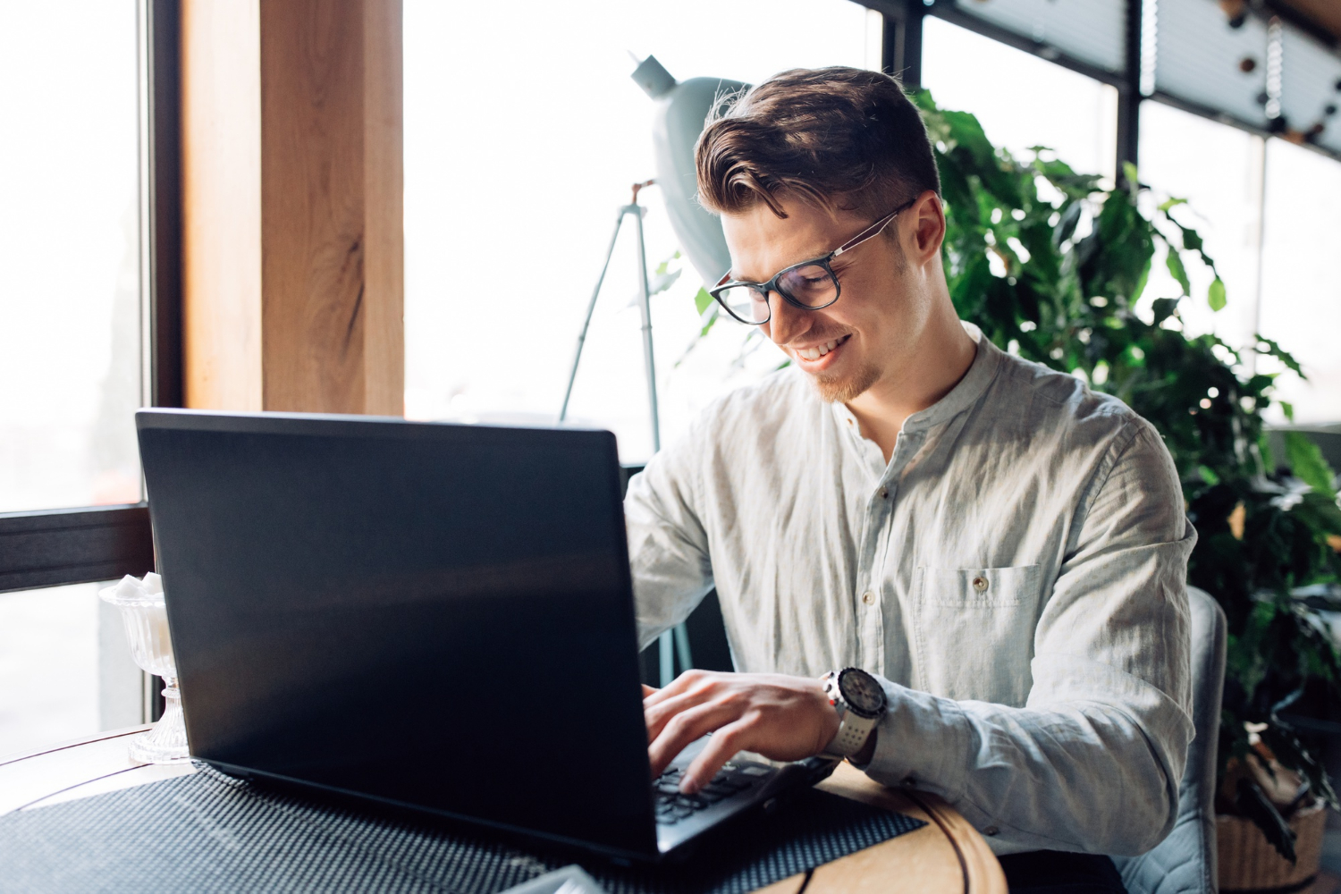 A man using a laptop at an office.