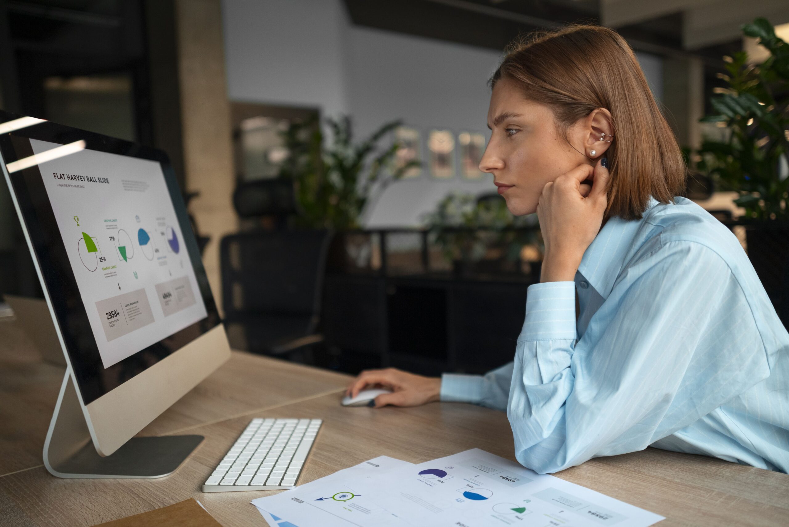 Awoman using an office computer.
